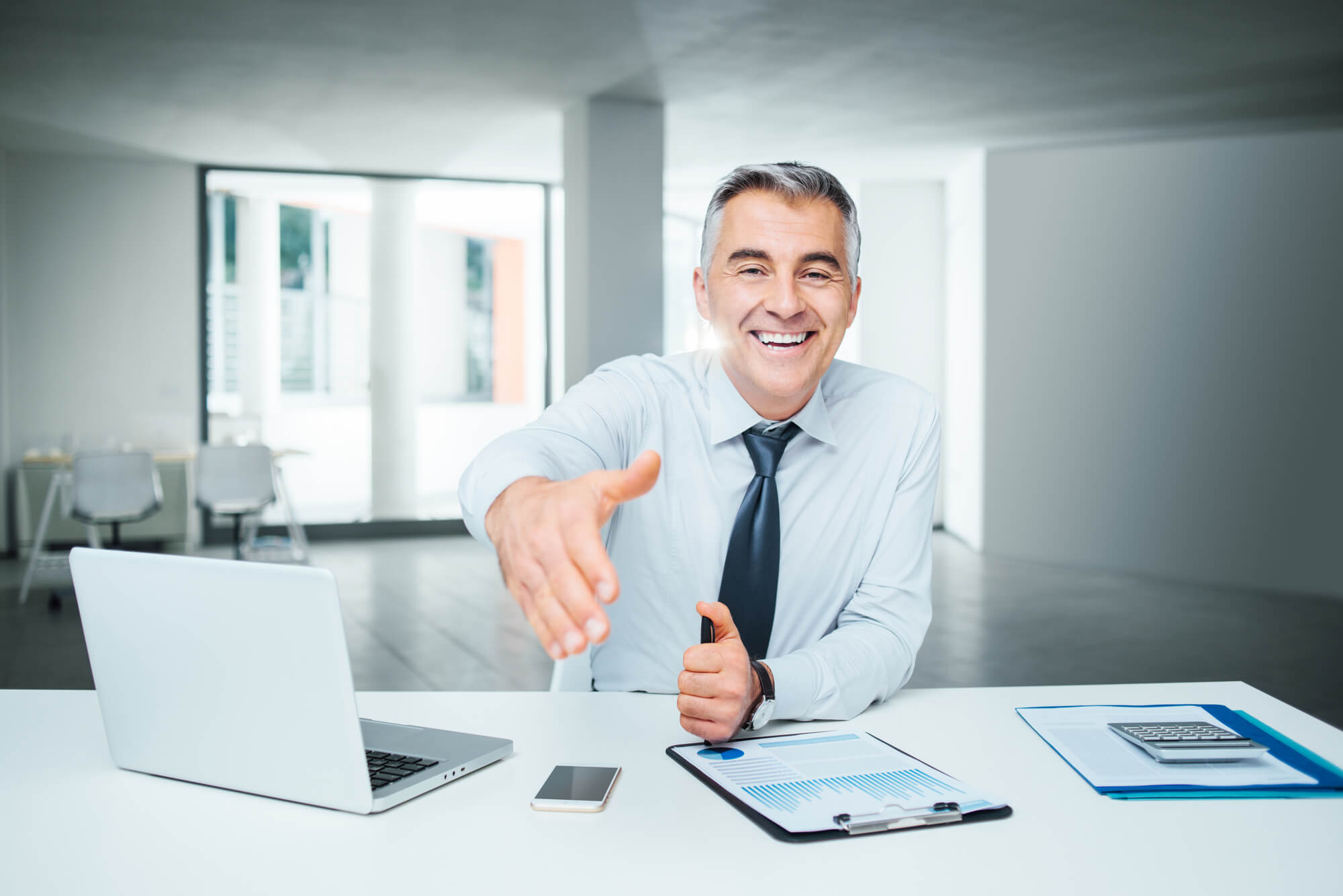 a credit counselor giving someone Drowning in Credit Card Debt a handshake
