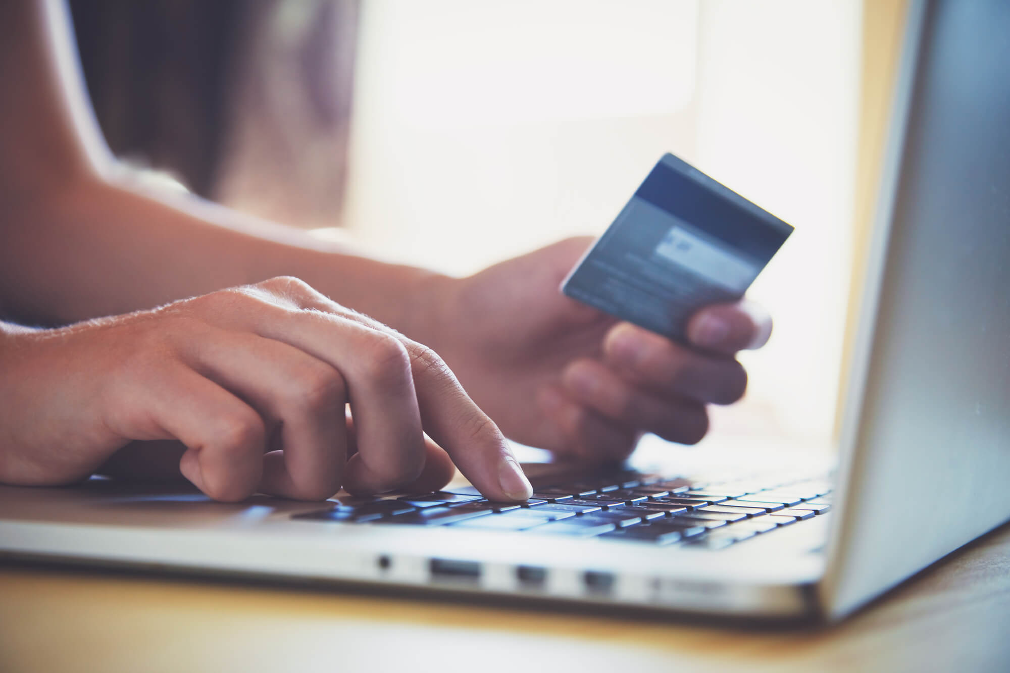 a man using a credit card and needing nonprofit credit counseling
